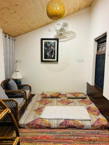 a bedroom with a bed and a ceiling fan at The Hp 39 House in Dharmsāla