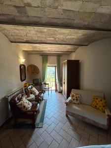 a living room with couches and a table at Il Castello sul Lago in Arrone