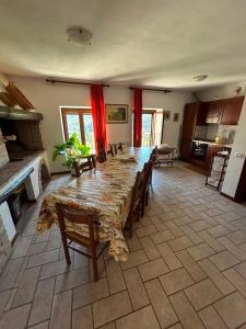 a large dining room with a long table and chairs at Il Castello sul Lago in Arrone