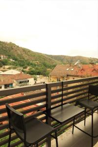 two chairs sitting on top of a balcony with a view at Apartment in Shtip in Štip