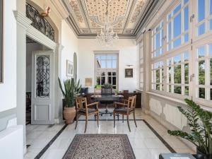 a dining room with a table and chairs and a chandelier at Villa Andromeda in Chania