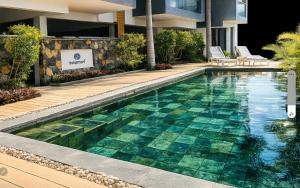 a swimming pool in front of a building at Beach luxury Penthouse in Flic-en-Flac