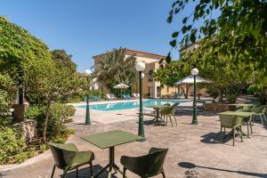 a group of tables and chairs next to a pool at Villa Andromeda in Chania