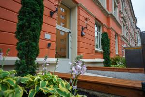 a building with trees and flowers in front of it at MAYA Apartments - Vika in Oslo