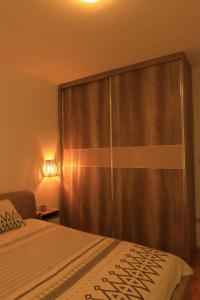 a bedroom with a bed with a large sliding door at Apartment in Shtip in Štip