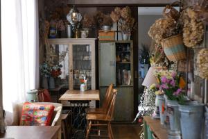 a dining room with a table and a refrigerator at 7 Rooms Hotel & Cafe - ディズニーと空港までバス1本 - 全室キッチン付き in Tokyo