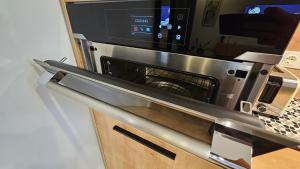 a microwave oven sitting on top of a counter at Lake Apartment in Šiauliai
