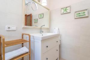 a bathroom with a sink and a mirror at Sol I Vent in Cala Santanyi +38 photos