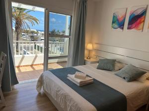 a bedroom with a bed with a view of a balcony at Villa Crotos in Costa Teguise