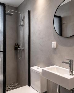a bathroom with a toilet and a sink and a mirror at PAME Wild in Athens +59 photos