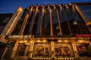 a building with a store front at night at Airport La Sapphire Hotel & Restaurant in New Delhi
