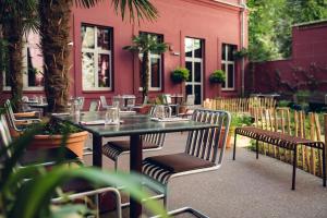 a table and chairs in front of a red building at The Companion Vienna in Vienna