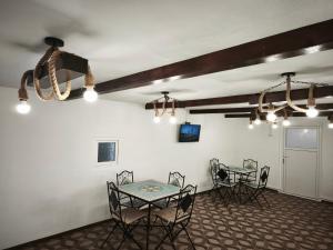 a dining room with a table and chairs and lights at Bunătăți din Retezat in Nucşoara