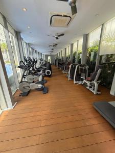 a gym with a row of treadms and machines at vortex luxury APATMENT BY FRINDSHIP in Kuala Lumpur