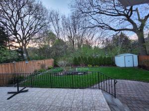 a black gate in a yard with a fence at Executive Room in North York Centre in Toronto