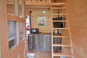 a tiny house with a desk and a computer at Grajski oddih in Cerklje na Gorenjskem