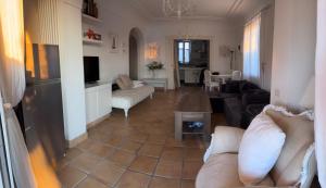 a living room with a couch and a table at VILLA CLARA ISCHIA piscina riscaldata e idromassaggio in Lacco Ameno
