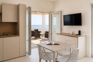 a kitchen and dining room with a table and chairs at Almarea Cirò Marina in Cirò Marina