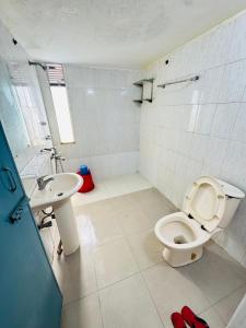 a bathroom with a toilet and a sink at Hotel Impulse Ocean View in Cox's Bazar