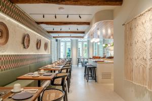 a row of tables and chairs in a restaurant at NOLIA Boutique Hotel in Porto