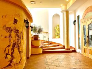 a hallway of a building with a staircase and a building with at Papuga Park Hotel Wellness Marrakesz & SPA in Bielsko-Biała