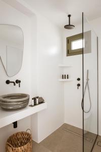 a bathroom with a sink and a mirror at Halo Tinos - PHOEBUS in Tinos