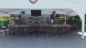 a bar with a bunch of chairs around it at Hotel Riverside in Dalyan