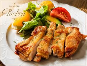 a plate of food with chicken and vegetables and fruit at Nakao Kogen Hotel Kazaguruma in Takayama