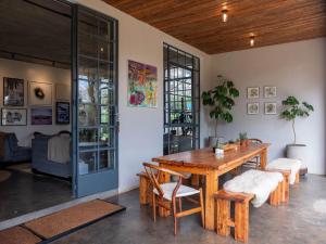 a dining room with a wooden table and chairs at Afrika House in Nairobi