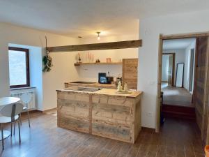 a kitchen with a wooden island in a room at Maison BelleVue in Châtillon +24 photos