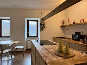 a kitchen with a counter and a table in a room at Maison BelleVue in Châtillon