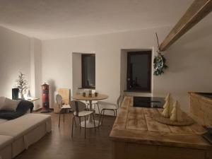 a living room with a couch and a table at Maison BelleVue in Châtillon