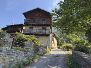 a building with a balcony on the side of a road at Maison BelleVue in Châtillon