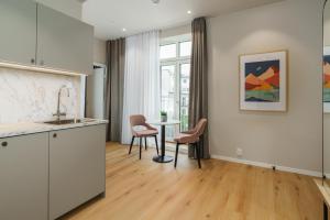 a kitchen and dining room with a table and chairs at MAYA Apartments - Vika in Oslo