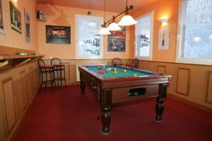 a room with a pool table with balls on it at Hôtel Bar Restaurant de la Poste Le 1900 in Jougne