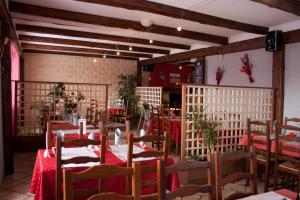 a restaurant with tables and chairs in a room at Hôtel Bar Restaurant de la Poste Le 1900 in Jougne