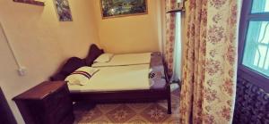 a small bed in a room with a window at lala salama in Zanzibar City +7 photos