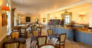 a restaurant with a bunch of chairs in a room at Château de Pourtalès in Strasbourg