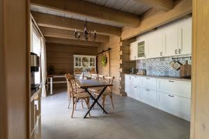 a kitchen with a table and chairs in a room at Przytulisko Bieszczady in Smerek