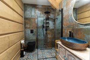 a bathroom with a sink and a shower at Przytulisko Bieszczady in Smerek +78 photos