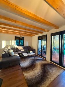 a living room with a couch and a table at Hidden pines in Gornji Čevljanovići