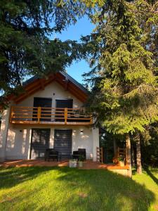 a house with a deck and a balcony at Hidden pines in Gornji Čevljanovići
