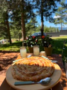 a pizza sitting on a plate on a table at Hidden pines in Gornji Čevljanovići +17 photos