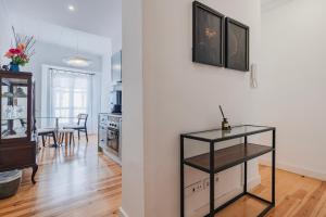a living room with a table and a kitchen at A cozy hideout in Lisbon +21 photos
