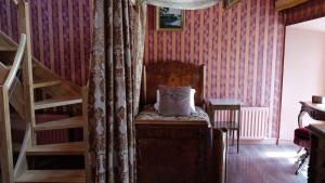 a room with a chair with a pillow on it at Börsen Apartment Suites in Visby
