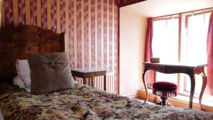 a bedroom with a bed with a pillow on it at Börsen Apartment Suites in Visby