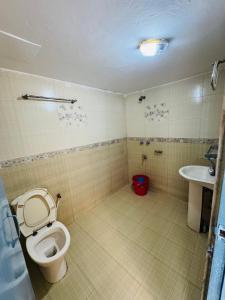 a bathroom with a toilet and a sink at Hotel Impulse Ocean View in Cox's Bazar +19 photos