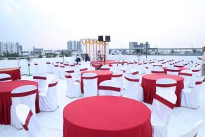 a group of red and white tables and chairs at Kings Residency in Chennai