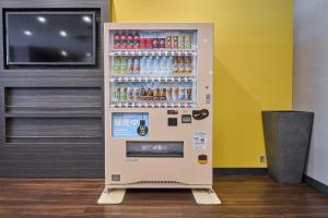a soda vending machine in a room with a tv at Smile Hotel Tokyo Nihonbashi in Tokyo