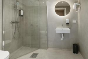 a bathroom with a shower and a sink at MAYA Apartments - Vika in Oslo